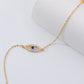 Gold necklace with a blue gemstone on a white background