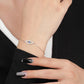 Close-up of a hand wearing a silver bracelet with an eye design 