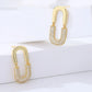 Gold hoop earrings with embedded stones on a white background