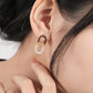 Gold and diamond earring worn by a woman