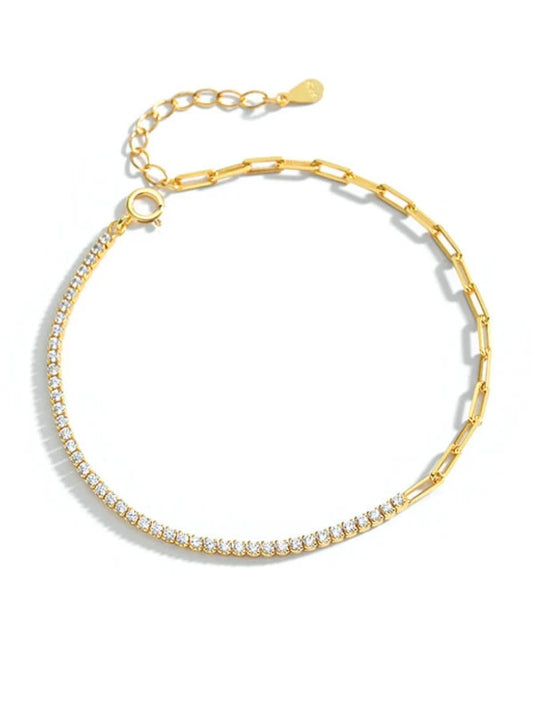 Gold bracelet with clear stones on a white background