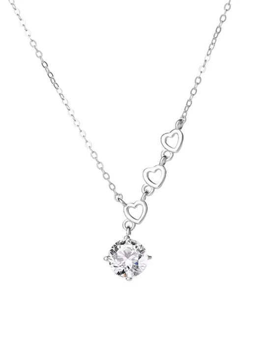 Silver necklace with a heart-shaped pendant and central diamond on a white background