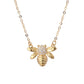 Gold bee-shaped necklace with a diamond on a white background