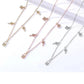 Three gold necklaces with butterfly pendants on a white background