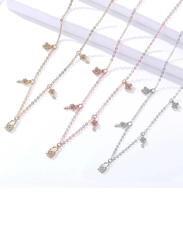 Three gold necklaces with butterfly pendants on a white background
