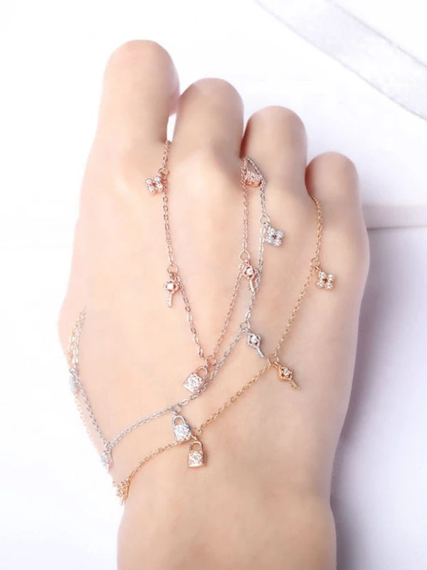 Delicate bracelet with small crystals on a hand against a white background