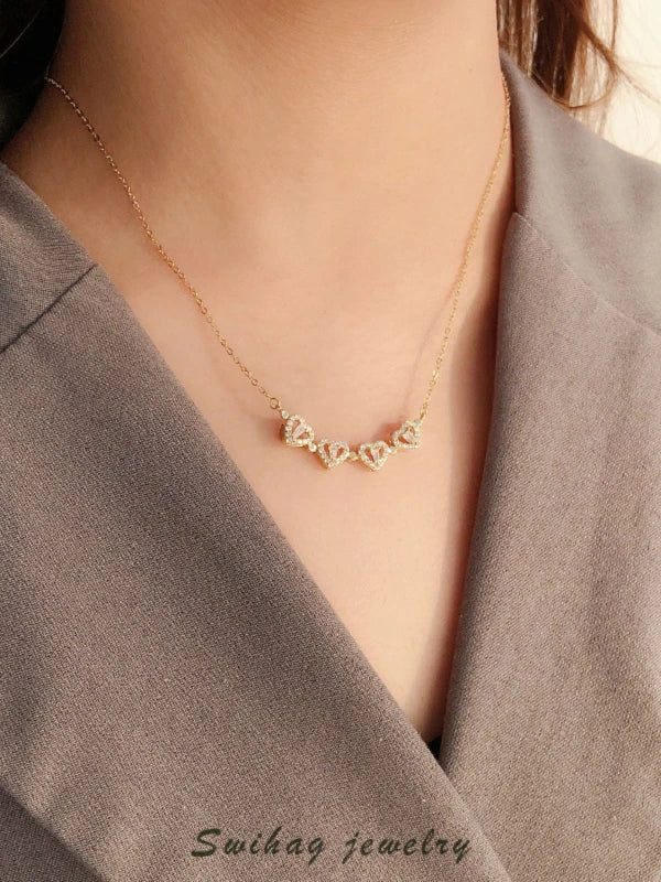 Gold necklace worn by a woman.