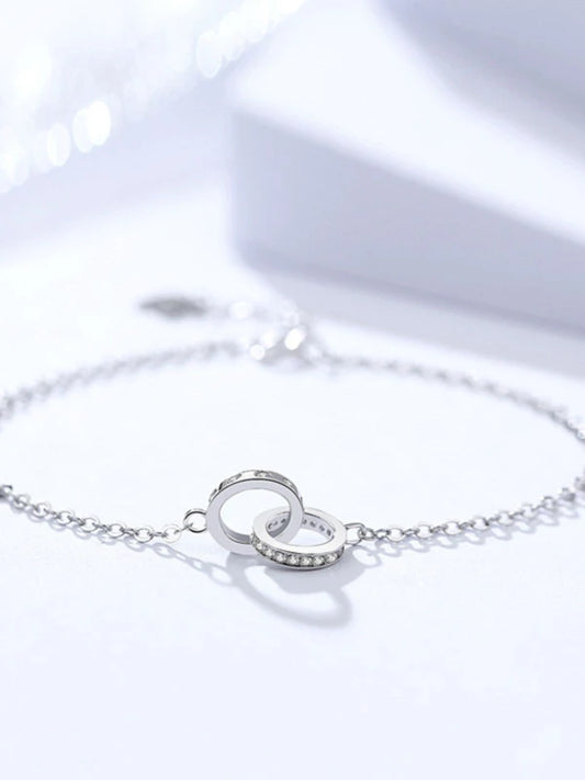 Silver bracelet with heart-shaped clasp on a white background