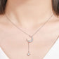 Necklace with a crescent moon and star pendant on a woman wearing a white top.