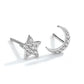 Silver star and moon earrings on a white background