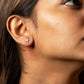 Close-up of a person wearing a star-shaped earring.