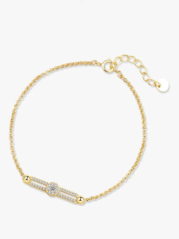 Gold bracelet with a diamond on a white background