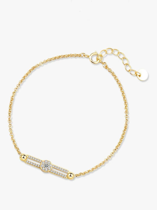 Gold bracelet with a diamond on a white background