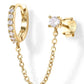Gold hoop earring with chain and matching stud earring on a white background