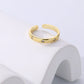 Gold ring with star designs on a white background