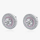 Pair of silver earrings with pink gemstones on a white background