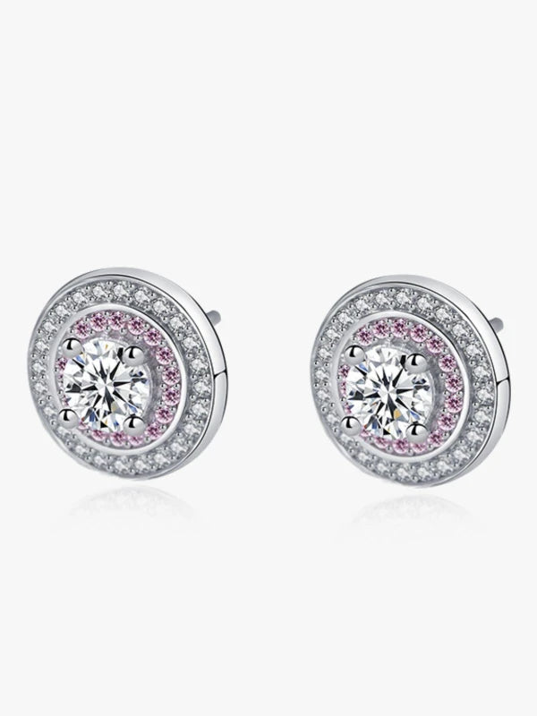 Pair of silver earrings with pink gemstones on a white background