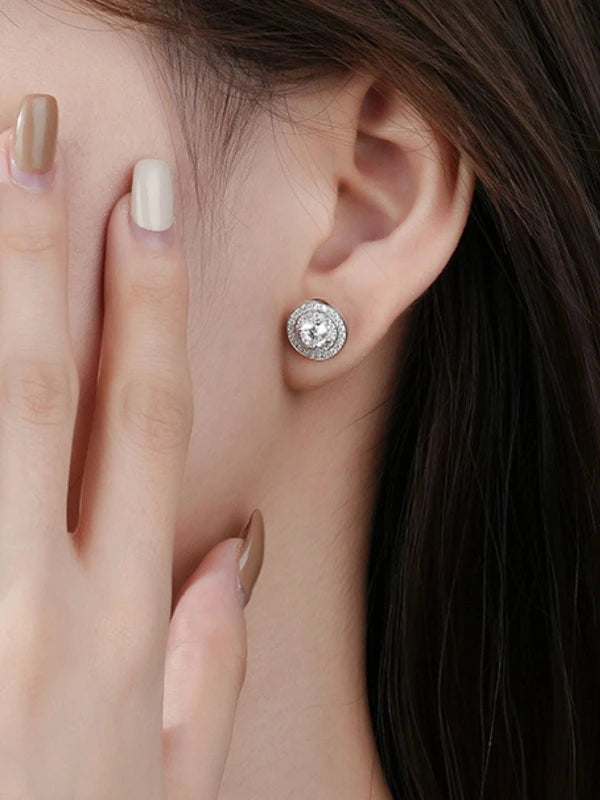 Close-up of a woman wearing a diamond stud earring with a blurred background