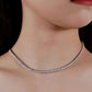Close-up of a woman wearing a silver necklace