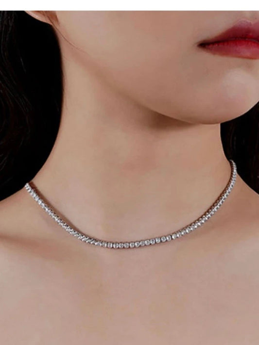 Close-up of a woman wearing a silver necklace