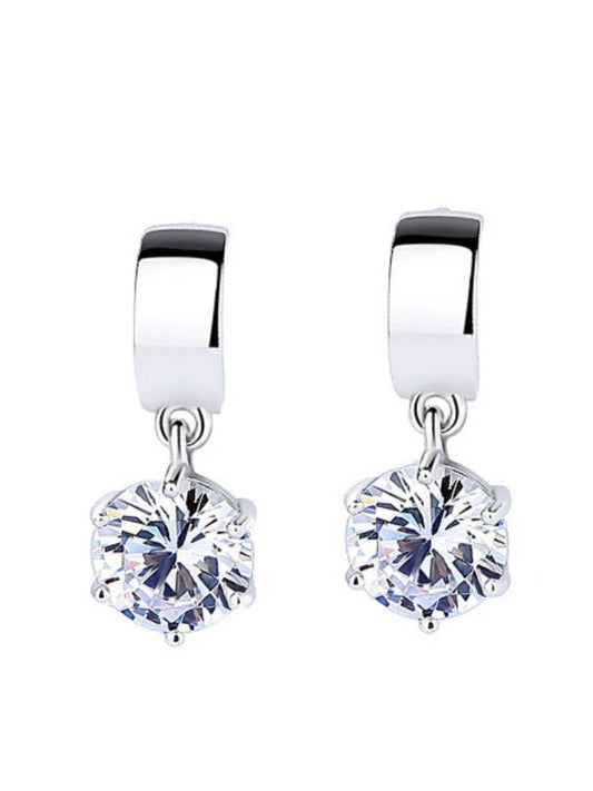 Pair of silver earrings with clear gemstones on a white background