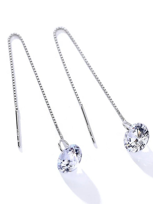 Pair of silver earrings with clear gemstones on a white background