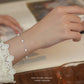 Silver bracelet on a wrist with a blurred background