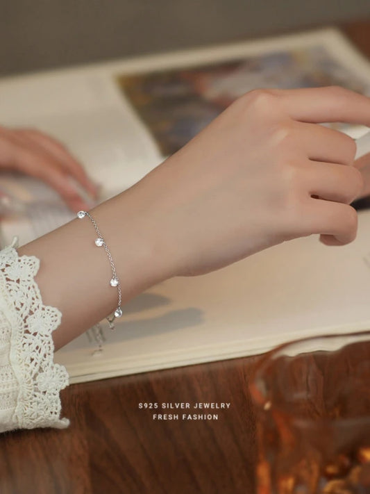 Silver bracelet on a wrist with a blurred background