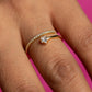 Close-up of a hand wearing a diamond ring on a pink background