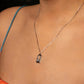 Necklace with a pendant worn by a person