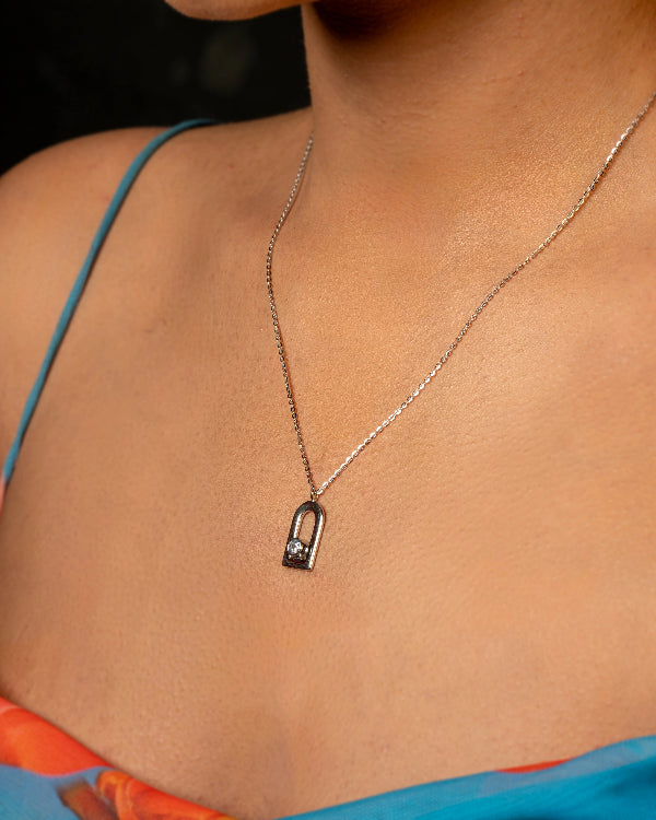 Necklace with a pendant worn by a person