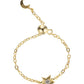 Gold bracelet with star and moon charm on a white background