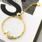 Gold bracelet with moon and star designs on a magazine background