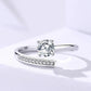 Silver ring with a diamond on a light gray background