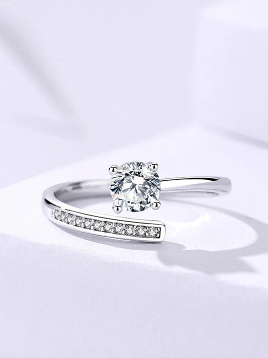 Silver ring with a diamond on a light gray background