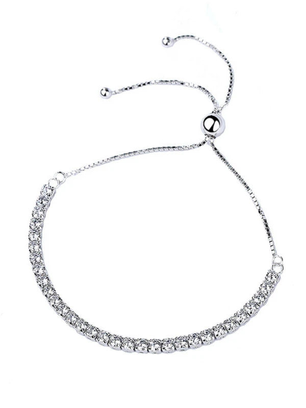 Silver bracelet with clear stones on a white background