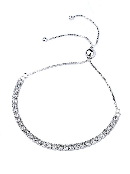 Silver bracelet with clear stones on a white background