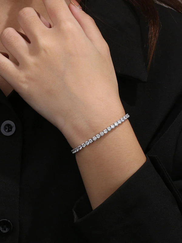 Silver bracelet on a person's wrist with a blurred background