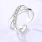 Silver ring with diamond accents on a light gray background