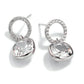 Silver earrings with clear gemstones on a white background